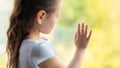 Lonely Kid Girl Standing Near Window At Home Looking Outside Royalty Free Stock Photo