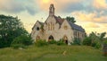 Lonely lamb lies in front of a decaying church in the countryside in Barbados.