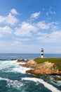 Lonely lighthouse on the coast of Galicia, Spain. Island of Pancha near Ribadeo Royalty Free Stock Photo