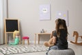 Lonely girl with toy bunny at home, back view. Autism concept Royalty Free Stock Photo