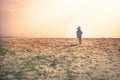 Lonely lost child toddler standing alone in sand dunes exploring childhood travel lifestyle