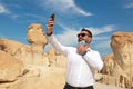 Lonely male tourist at Al Qarah Mountain taking selfie with mask Royalty Free Stock Photo