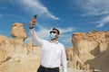 Lonely male tourist at Al Qarah Mountain taking selfie with mask Royalty Free Stock Photo