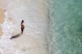 Lonely man on an empty sea turquoise beach under the sun. Rest and relaxation at the sea