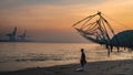 Lonely man fisherman Chinese fishing nets during the Golden Hours at Fort Kochi, Kerala, India Royalty Free Stock Photo