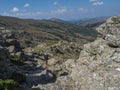 Lonely man hiker at Gennargentu Mountain, highest mountain in Sardinia, Nuoro, Italy. Vaste peaks, dry plains and Royalty Free Stock Photo