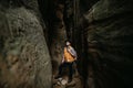 A lonely man Hiker stands in a mountain cave, travel concept