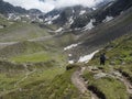 Lonely man hiker at Stubai hiking trail, Stubai Hohenweg at green summer alpine mountain valley in Stubai Tyrol Royalty Free Stock Photo