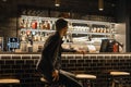 A lonely man sits at the bar waiting for his order. man in an empty bar in a cafe. Vik, Iceland, January 2020 Royalty Free Stock Photo