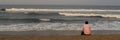 A lonely man sitting on the beach Royalty Free Stock Photo