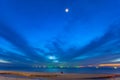 a lonely man sitting on the beach at twilight Royalty Free Stock Photo