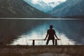 A lonely man sitting on the bench in front of the lake Royalty Free Stock Photo