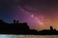 A lonely man sitting on the cliffs at sunset with mily night view Royalty Free Stock Photo