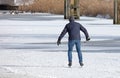 Lonely man skating on natural ice, Netherlands