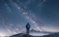 A lonely man standing against the background of a starry sky