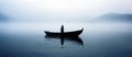 A lonely man standing in a boat in the middle of a lake. Overcast, foggy wheather Royalty Free Stock Photo