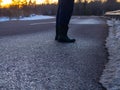 Free silhouette man walking on the deserted road, clouds, backlit at sunset, selective focus Royalty Free Stock Photo