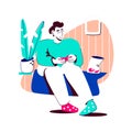 Lonely man in sweater sits in his apartment and plays a gamepad, next to chips and a plant. An ordinary evening at home