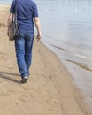 A lonely man walking on the beach. the concept of depression or rest Royalty Free Stock Photo