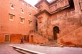 Lonely man walking past the 16th century Fort in India