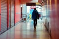 Lonely man walking in a shopping alley awith the shops closed on each side