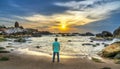 The lonely man watches the sunrise on a sandy beach Royalty Free Stock Photo