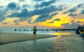 He lonely man watches the sunset on a sandy beach Royalty Free Stock Photo