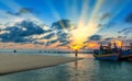 He lonely man watches the sunset on a sandy beach Royalty Free Stock Photo