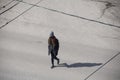 Lonely masked girl walking the street during quarantine