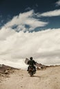 Lonely motocyclist traveler on mountain rosad in Himalaya Royalty Free Stock Photo