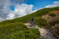 Lonely mountain cyclist on rocky trail high in the mountains. Kasprowy Wierch, Tatra Mountains, Poland.