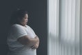 Lonely obese woman standing near the window Royalty Free Stock Photo