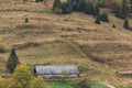 A lonely old barn at foot of mountain in fall Royalty Free Stock Photo