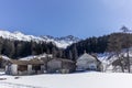 A lonely old farm on the empty and deserted ski slopes during the corona virus lockdown in the Swiss Alps Royalty Free Stock Photo