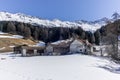 A lonely old farm on the empty and deserted ski slopes during the corona virus lockdown in the Swiss Alps Royalty Free Stock Photo