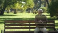 Lonely old man disappearing from bench, concept of death, transience of life Royalty Free Stock Photo