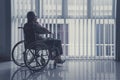 Lonely old man sitting on wheelchair at home Royalty Free Stock Photo