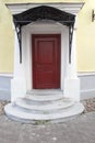 Lonely old red door on the street with semicircular steps Royalty Free Stock Photo