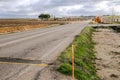Lonely old road with roadwork signs through the countryside. Royalty Free Stock Photo