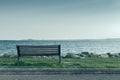 Lonely bench on sea coast Royalty Free Stock Photo