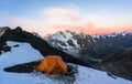 Lonely orange tent climbers in the high moutains