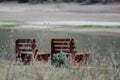 Lonely Pair of Wooden Benches Waiting Patiently Beside the Water Royalty Free Stock Photo