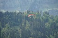 A lonely paraglider on the background of forest and mountain landscape im Engelberg region Obwalden, Switzerland