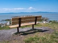 Lonely park bench overlooking the ocean Royalty Free Stock Photo