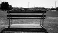 A lonely park bench at sporting ground Royalty Free Stock Photo