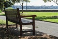 A lonely park bench in sydney harbour park Royalty Free Stock Photo