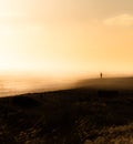 Lonely person on the beach and in the middle of the immensity of the landscape