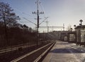 Lonely person on commuter train station a cold, winter morning. Royalty Free Stock Photo