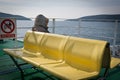 Lonely person sitting on the deck of a ferry boat Royalty Free Stock Photo