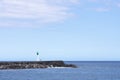 Lonely person standingnext to lighthouse at Saint Pierre harbor RÃÂ©union island